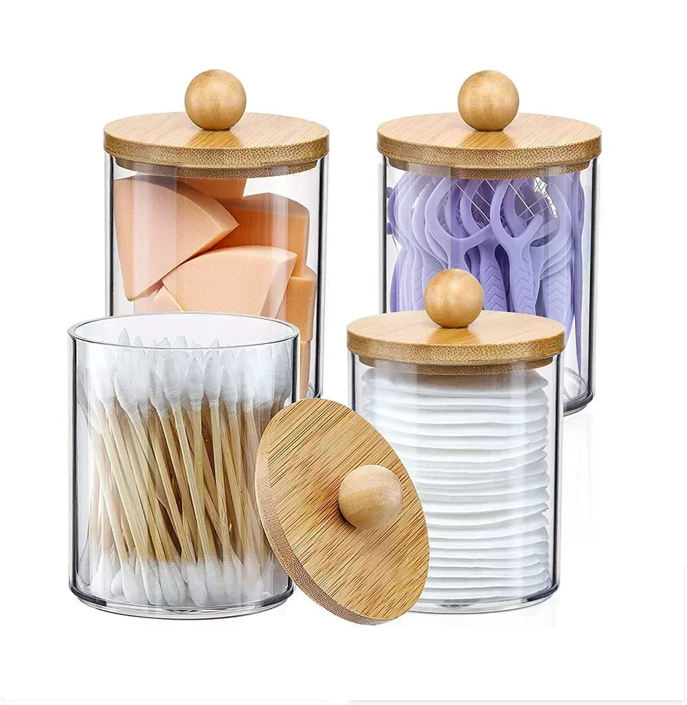 Clear acrylic apothecary jars with wooden lids filled with various toothbrushes