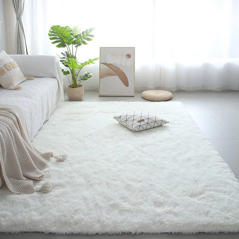 A fluffy white Nordic furry accent rug placed on a light floor with a sofa and potted plant in the background.
