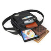 Black water-resistant multi-pocket crossbody chest bag with a strap and attached smartphone.
