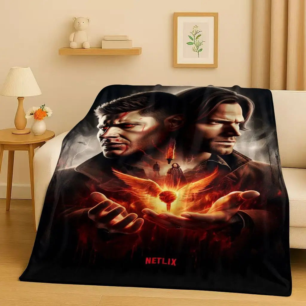 A dark graphic print featuring two intense male characters in leather attire with glowing orange wings and fire effects on a 