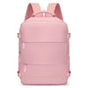 A pink compact cabin travel backpack with pink straps and multiple horizontal compression straps.