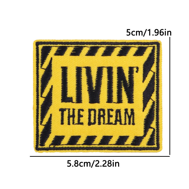 Yellow and black striped embroidered patch with the text LIVIN THE DREAM