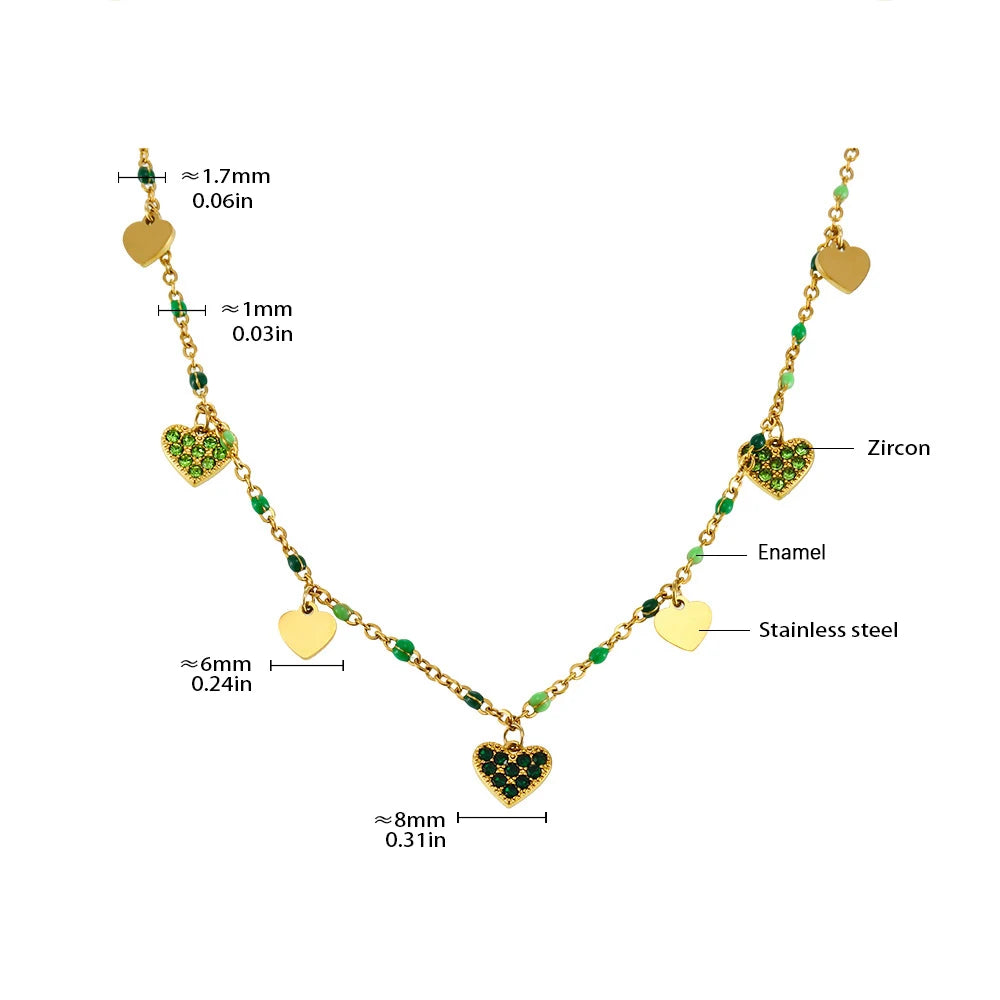 Gold-toned heart charm necklace featuring green enamel and zircon accents on a silver-toned chain.
