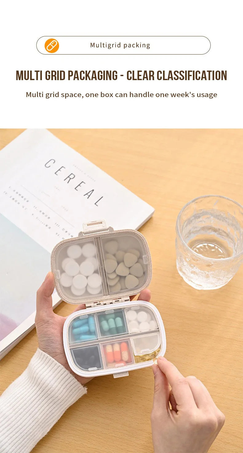 A hand holds an open weekly pill organizer with eight compartments, showing various colored pills and a clear glass of water.