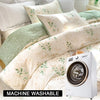 A white floral tea art print duvet cover set displayed on a bed with a washing machine nearby.