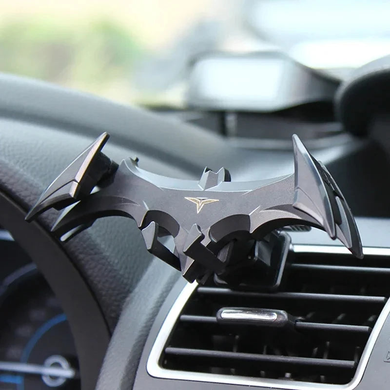 A black gravity car phone holder is shown mounted in a vehicle's air vent.