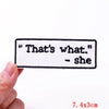 A white embroidered iron-on letter patch with the text That's what she.