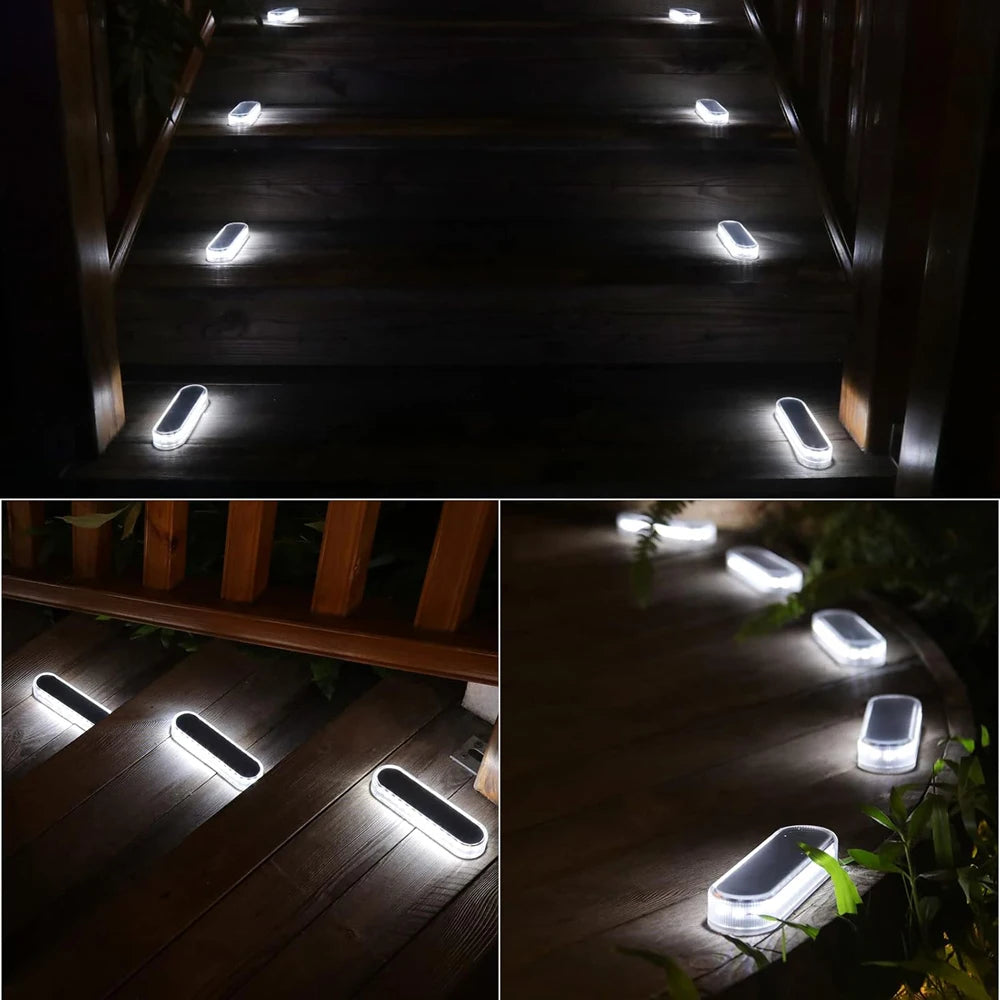 A set of solar powered LED step and path lights illuminating a wooden staircase and pathway at night.