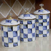 Three porcelain storage jars with a blue and white checkerboard pattern and gold lids