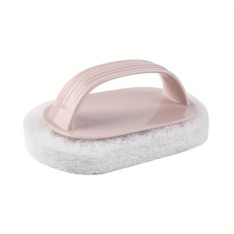 A pink magic sponge scrubber with a long handle rests on a white scouring pad.