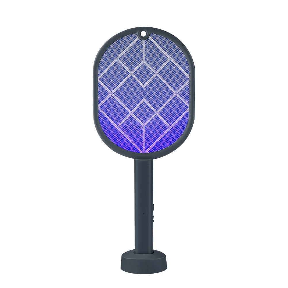 A black electric mosquito swatter with a hexagonal grid pattern illuminated by a purple UV light.