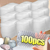 A hand holds a stack of 100 clear bubble mailers with cushioned protection.