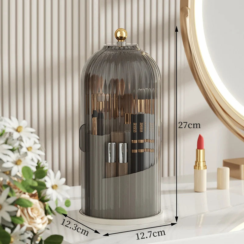A tall glass organizer for makeup brushes with a lid, shown next to a white surface.