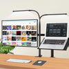 A modern desk setup featuring a laptop, keyboard, and a flexible monitor light bar with an adjustable arm.