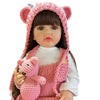 A lifelike silicone baby doll with pink ears and a matching knitted outfit.