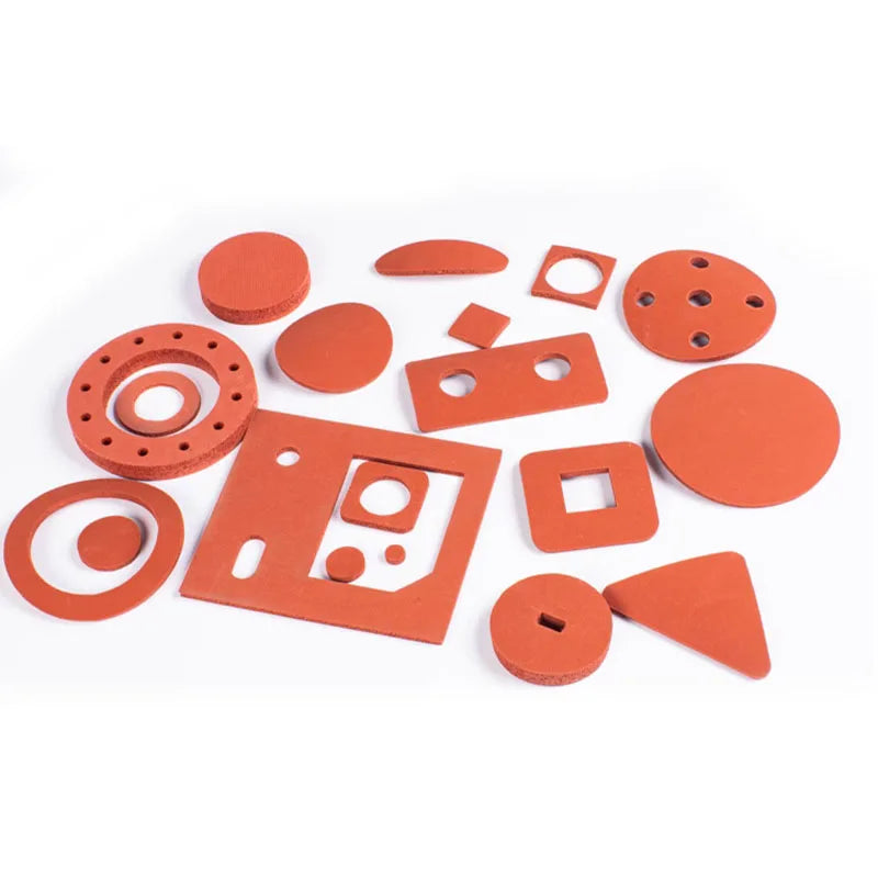 A collection of various orange silicone heat-resistant craft mats and components.