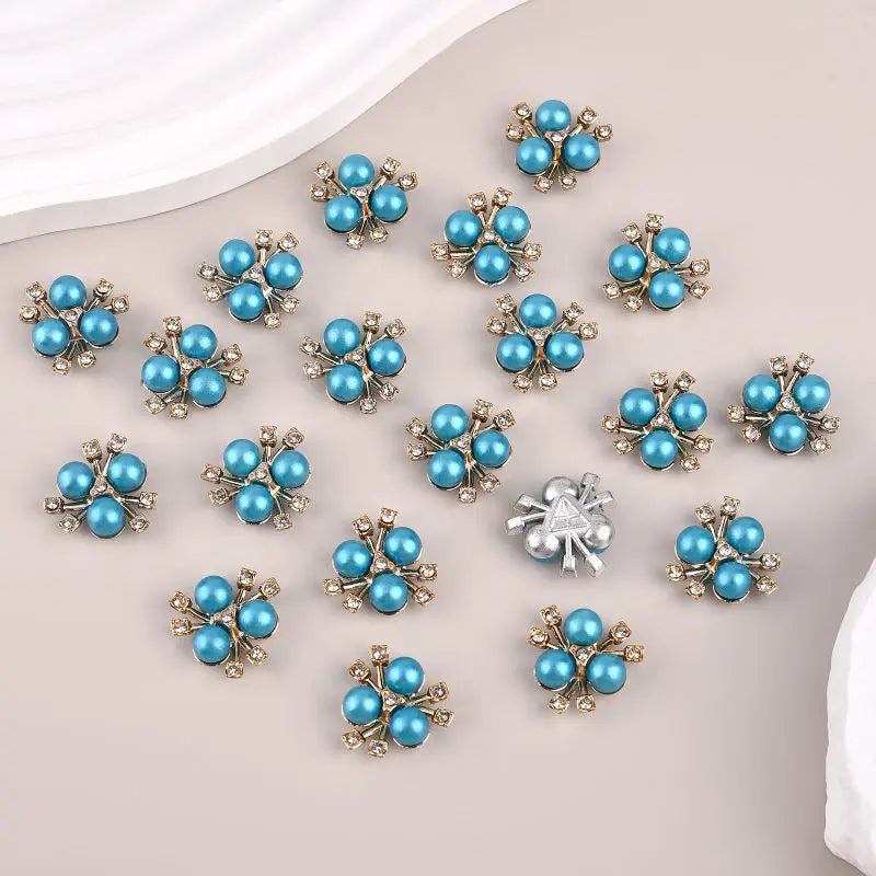 A collection of blue and silver pearlized resin flower beads for DIY jewelry and crafts.