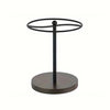 Black metal sunglasses organizer stand with a circular frame and wooden base