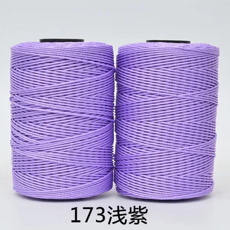 Two spools of purple 3-ply polyester knitting yarn for crochet and hand crafts