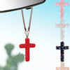 A red rhinestone cross pendant hanging from a silver chain, displayed against a light blue background.