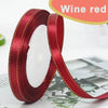 Roll of red satin ribbon with gold edge for crafts and gift wrapping