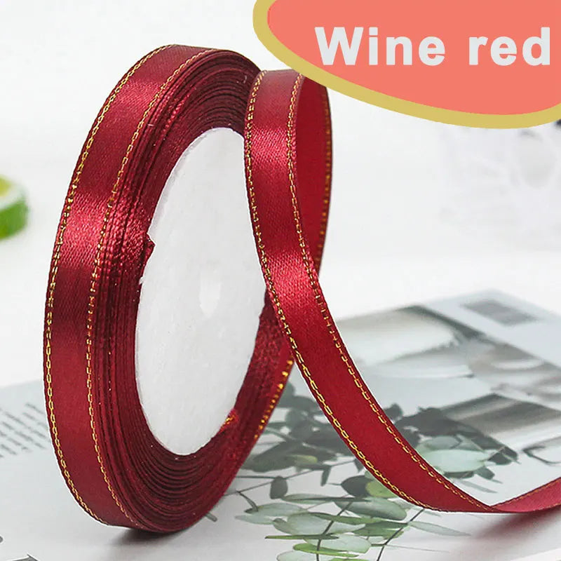 Roll of red satin ribbon with gold edge for crafts and gift wrapping