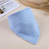 Light blue soft cotton baby bib with a textured pattern shown on a beige surface.