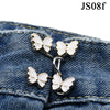 Silver butterfly buttons attached to denim fabric