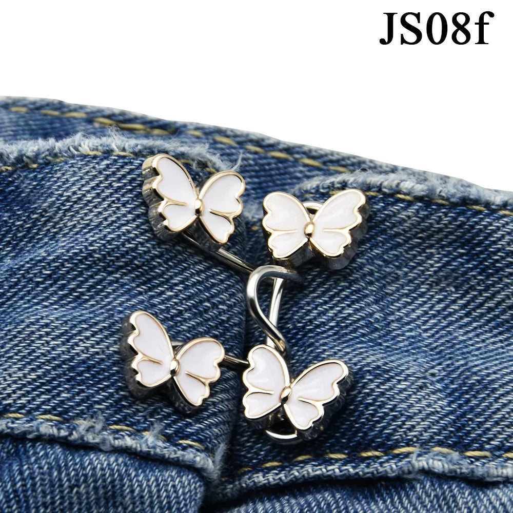 Silver butterfly buttons attached to denim fabric