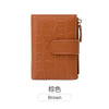 A brown leather compact zippered bi-fold wallet with card slots and a coin pocket.