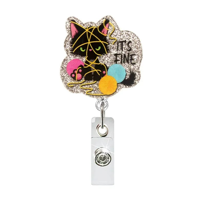 Glitter acrylic badge reel with an outline of a black cat face and the text Its Fine