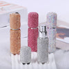A collection of ten refillable glass perfume atomizers in various glitter colors including rose gold, pink, silver, and iride