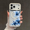 A hand holds a clear phone case featuring a blue lily floral design against a light background.