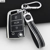 A silver car key cover with a black grip and metal clip, designed for VW, SEAT, and Skoda models.