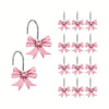 A set of twelve pink decorative bow tie shower curtain hooks.