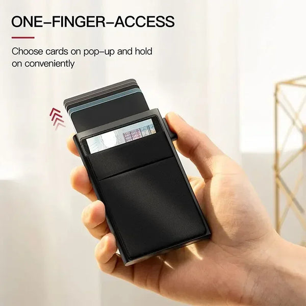 A hand holds a black minimalist RFID-blocking metal card wallet with a pop-up feature.