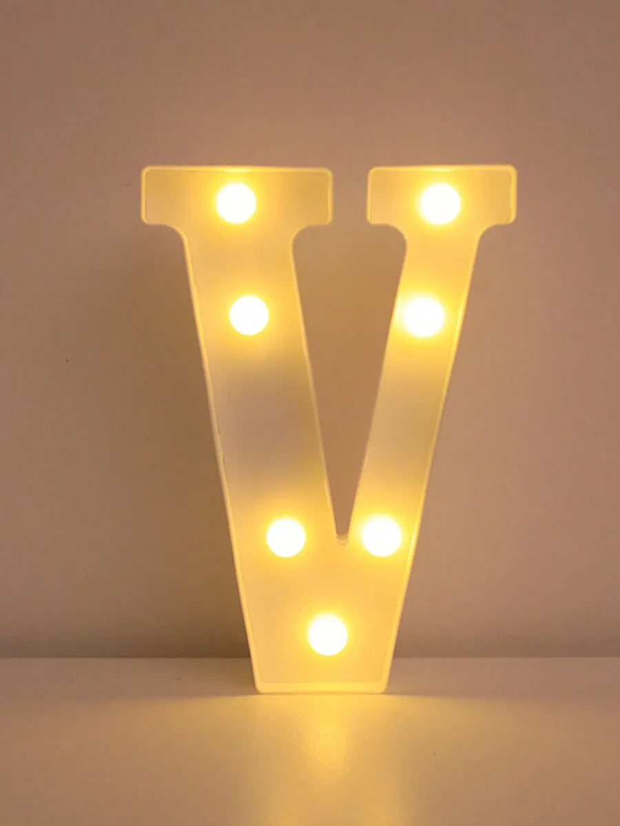 A glowing yellow LED letter night light shaped like the letter V, featuring multiple illuminated dots.