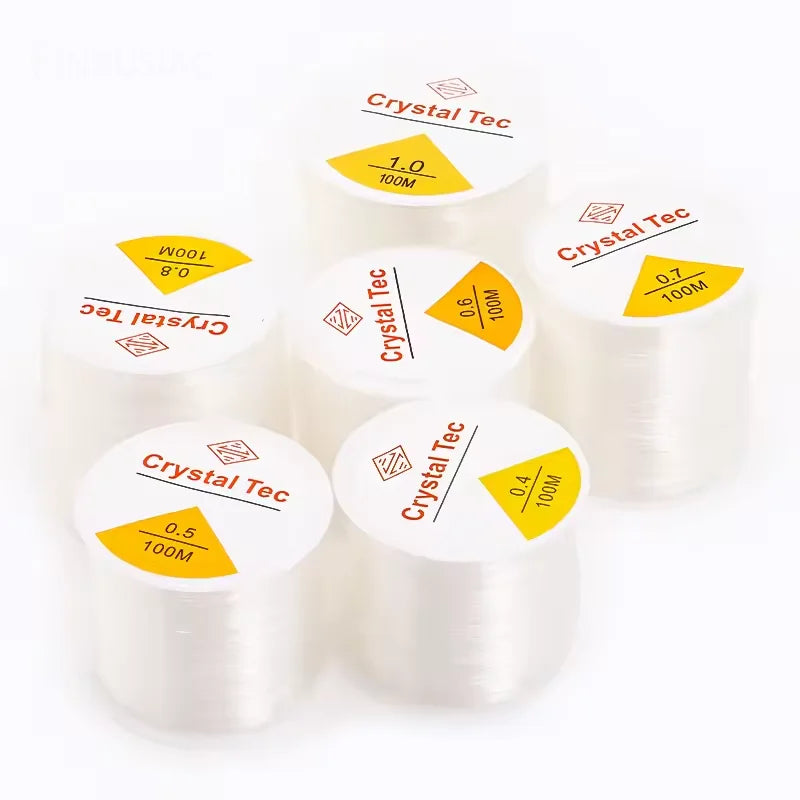 Rolls of transparent elastic cord for jewelry making and beading with various diameters labeled on the packaging