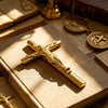 A gold crucifix pen set featuring a metal finish resting on an old book.