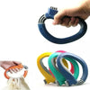 A hand is holding a blue ergonomic grocery bag carrier with a soft-grip handle, showing its design and function.