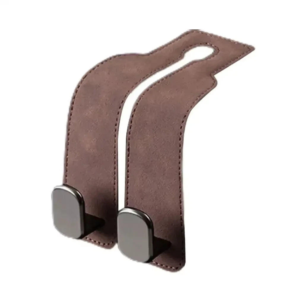 Brown suede storage hooks designed to attach bags or items to a car seat back.