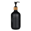 Black refillable soap dispenser bottle with a wooden pump top
