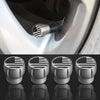 A set of four silver tire valve caps featuring an American flag design, shown in close-up against a metallic surface.