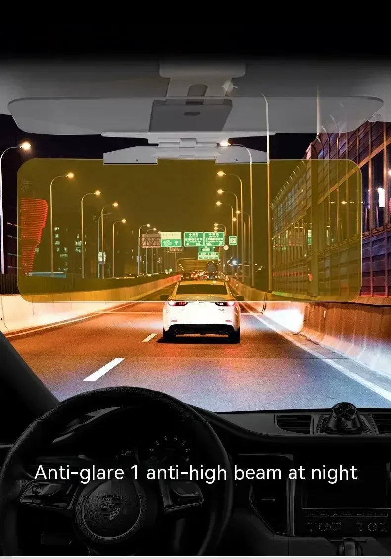 A car interior view showing an anti-glare visor extender with a night shield illuminating the road at night.