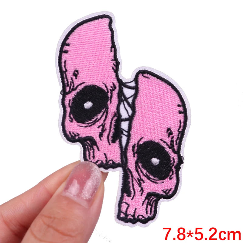Pink embroidered rose skull patch with black details and iron-on backing