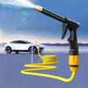 A black high-pressure car wash gun with a yellow hose is shown spraying water onto a white car.
