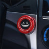 Close-up of a red and black rotating protective cover for a car ignition start button.
