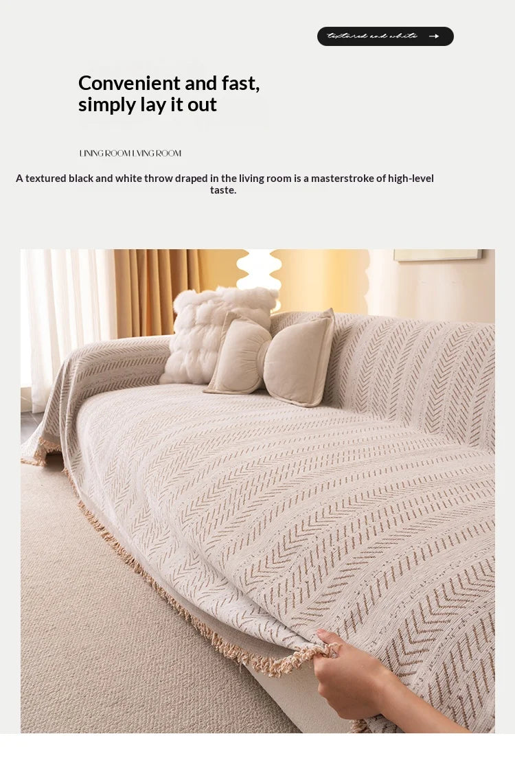 A beige textured anti-slip sofa cover with a herringbone pattern draped over a light-colored sofa.
