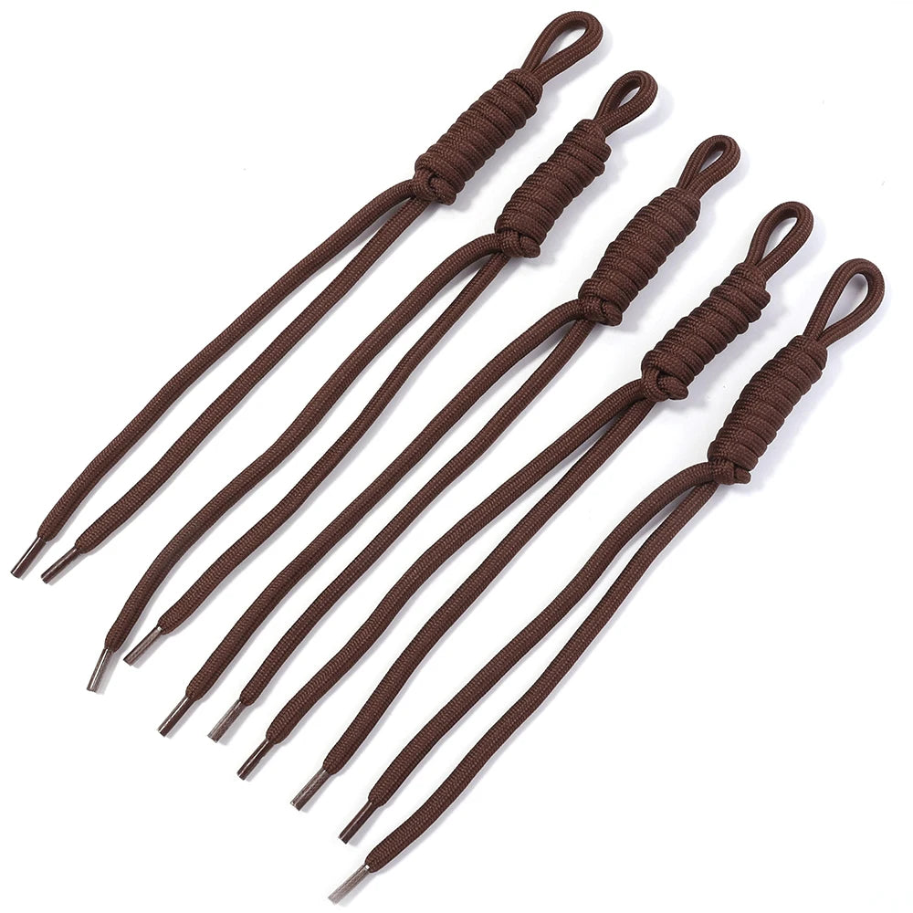A set of dark brown braided nylon lanyards with attached keychains.