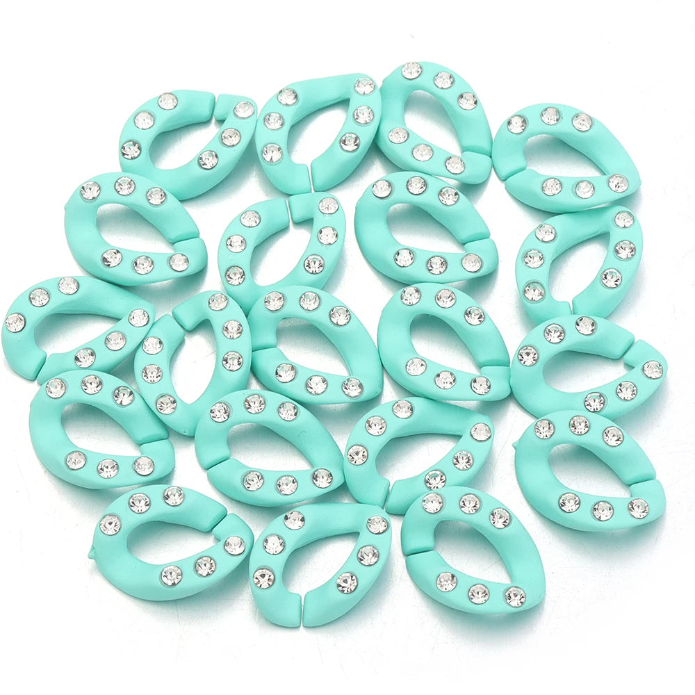 A set of twenty light mint green acrylic jewelry connector clasps with crystal accents.